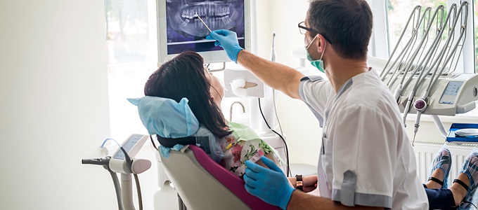 Dentist explaining x-ray of teeth to a patient