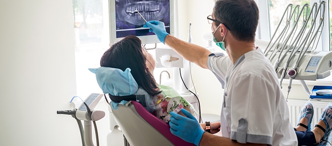 Dentist explaining x-ray of teeth to a patient