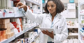 A pharmacy student checks medicine inventory