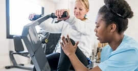 An student provides physical therapy to a patient